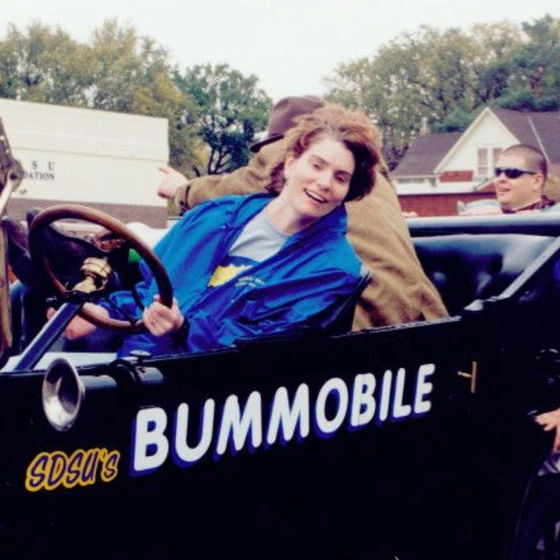 Bummobile from the 90s with students pushing it in the parade