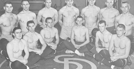 Kurtenbach, fourth from the left in the back row, poses with the wrestling team.