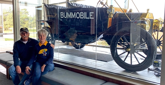 A couple sits in front of the bummoblie in the hobo day gallery