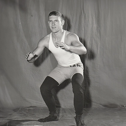 historic photo from a yearbook of verne winter in his sdsu wrestling single in a wrestling stance