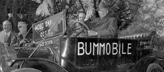 Dwight Eisenhower waves while sitting in the Bummobile