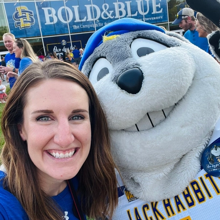 Jenn with Jack the Jackrabbit in front of the Foundation building