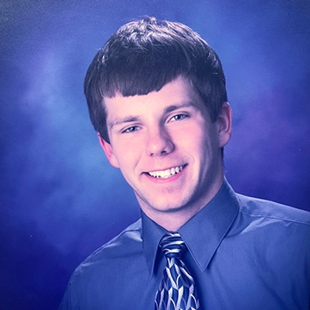 A young man smiling for a professional portrait photo