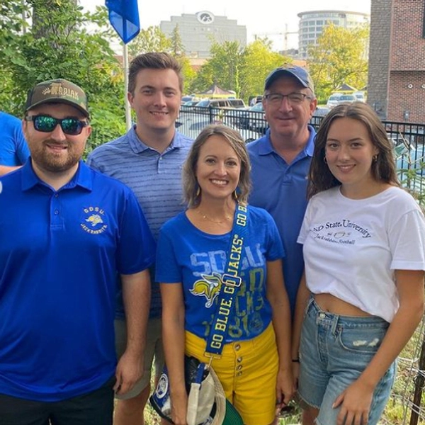 Julie and Marc Mooney smile with family members wearing jackrabbit gear