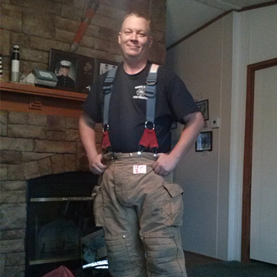 Kevin in firefighter coveralls