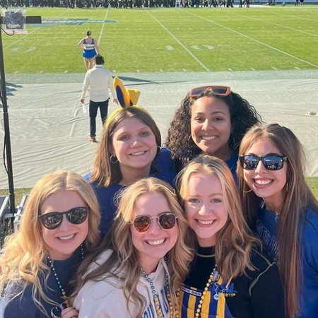 maddie and a group of friends at a football game