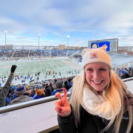 maddie fitch gives the "ears up" gesture during a sdsu football game