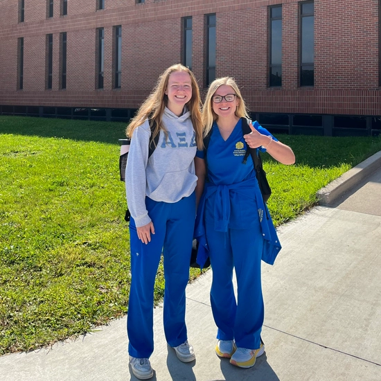 Two nursing students posing with a thumbs up