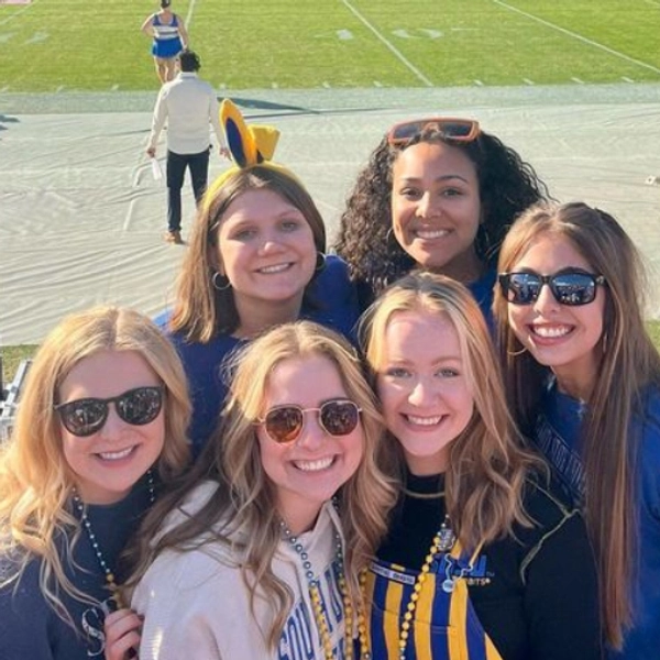 A group of girls in jackrabbit gear at a SDSU football game