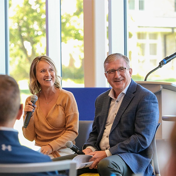 Julie and Marc Mooney speaking at an SDSU Foundation event.
