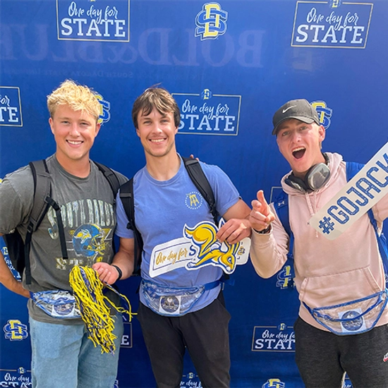 South Dakota State University students pose at a photobooth during One Day for STATE