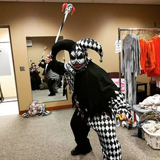 Robert is dressed in full costume and makeup as a black and white joker.