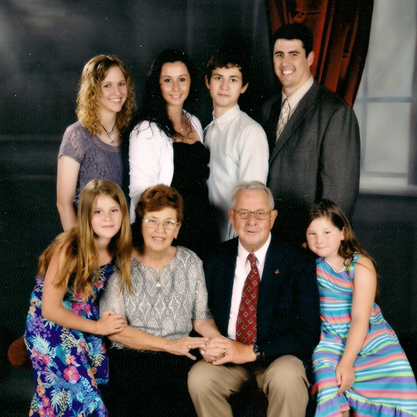 Lowell and Deanna Satterlee posing with their six grandchildren