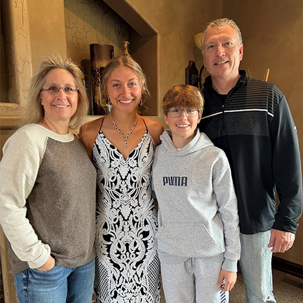 A young lady in a prom dress with 3 others
