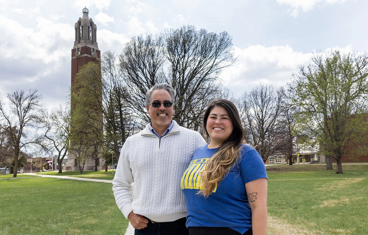 Freddy Moran Sr. and his daughter Sam stand together with the Coughlin Campanile in the background.