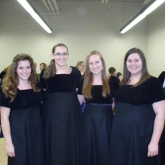 Marian Beck stands together with three other SDSU students in the women's choir.