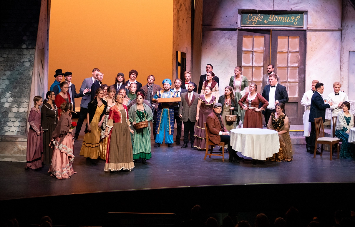 Large group of professional actors on stage along with SDSU students performing in a Woodbine Productions performance.