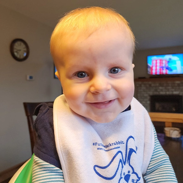 A small child wearing a Jackrabbit bib.