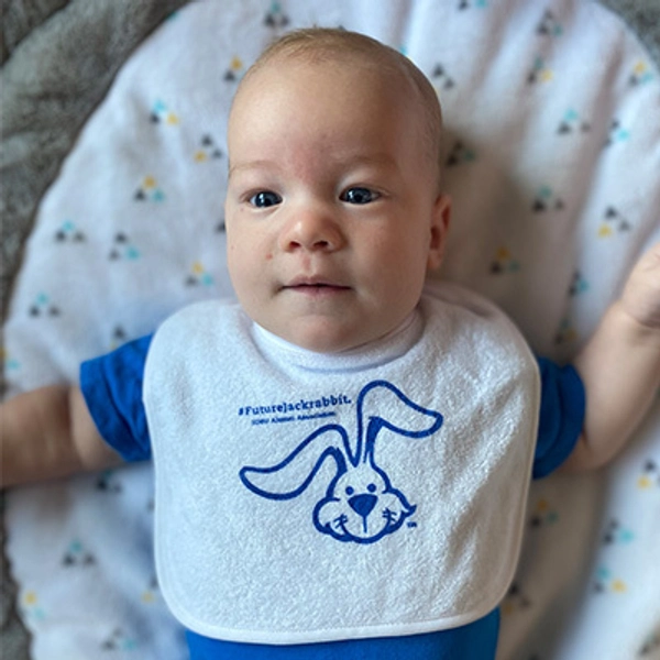 A small child wearing a Jackrabbit bib.