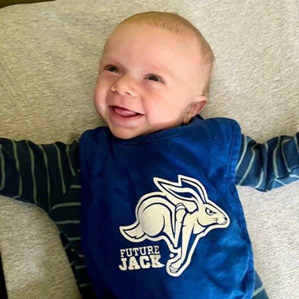A small child wearing a Jackrabbit bib.