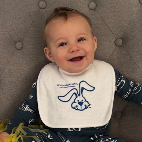 A small child wearing a Jackrabbit bib.