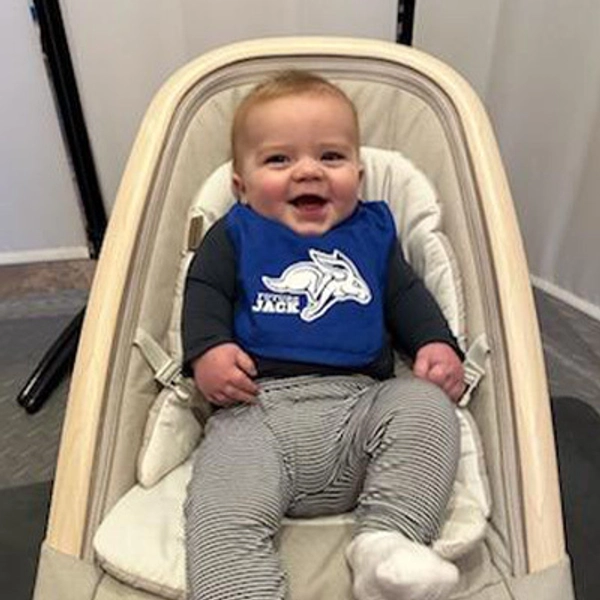 A small child wearing a Jackrabbit bib.