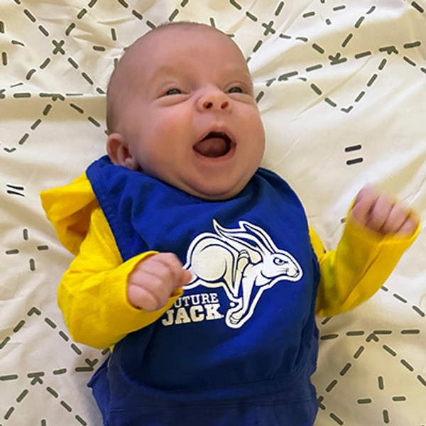A small child wearing a Jackrabbit bib.