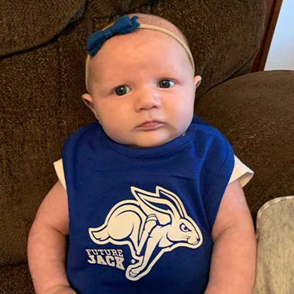 A small child wearing a Jackrabbit bib.