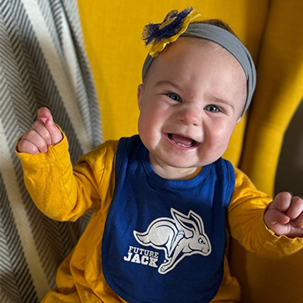 A small child wearing a Jackrabbit bib.