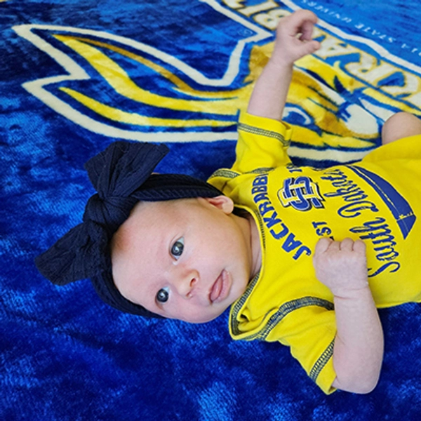 A small child wearing a Jackrabbit bib.