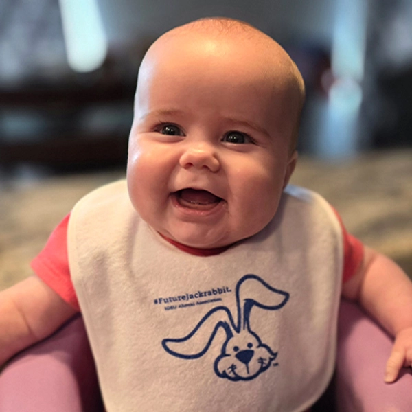 A small child wearing a Jackrabbit bib.