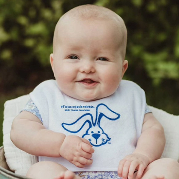A small child wearing a Jackrabbit bib.