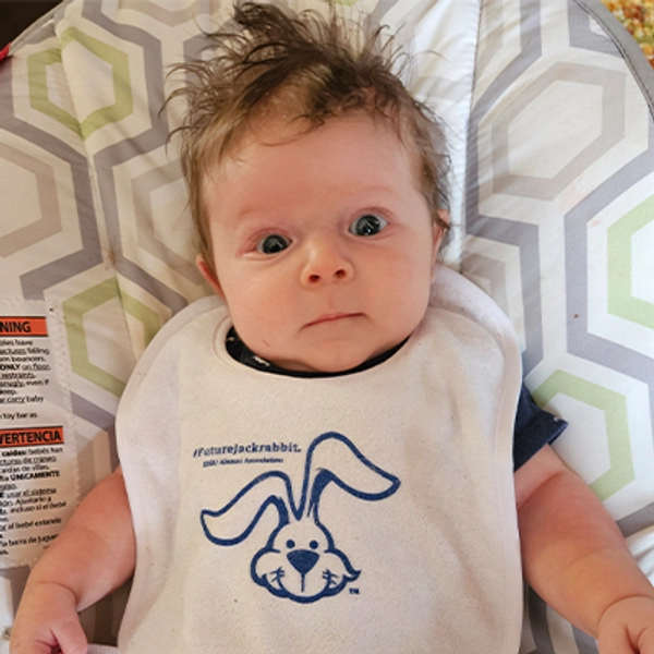 A small child wearing a Jackrabbit bib.