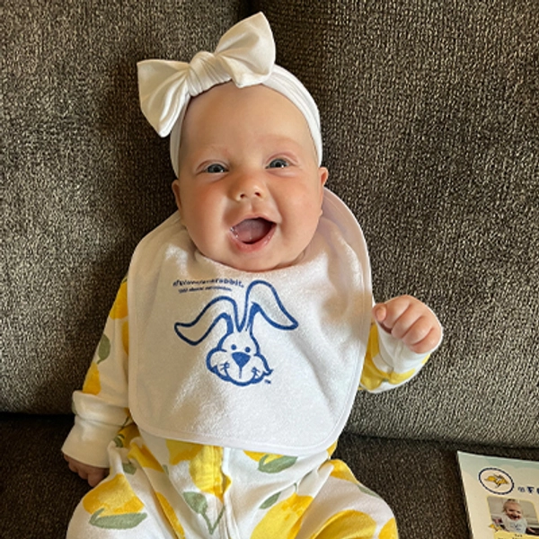 A small child wearing a Jackrabbit bib.
