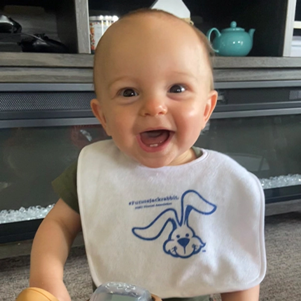 A small child wearing a Jackrabbit bib.
