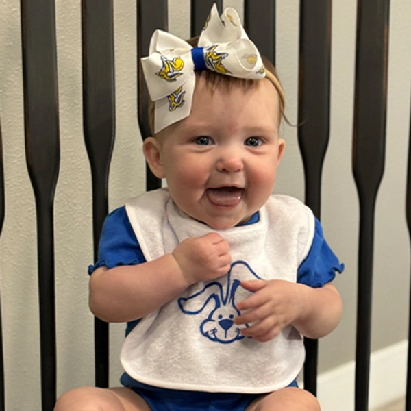 A small child wearing a Jackrabbit bib.
