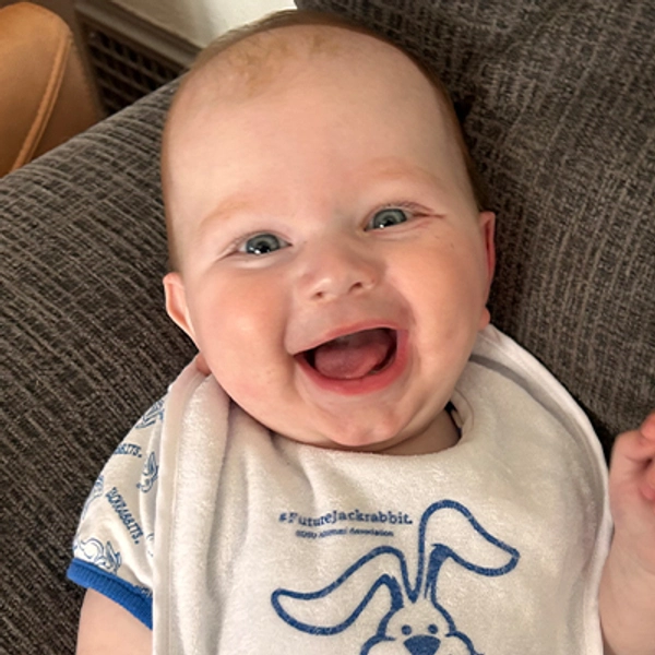 A small child wearing a Jackrabbit bib.