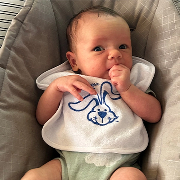 A small child wearing a Jackrabbit bib.