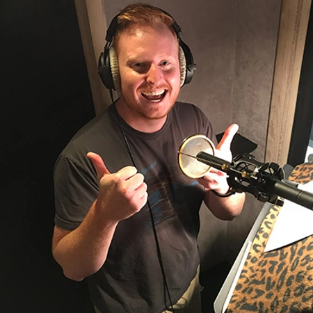 Thomas Hagena gives a thumbs-up while in a recording booth.