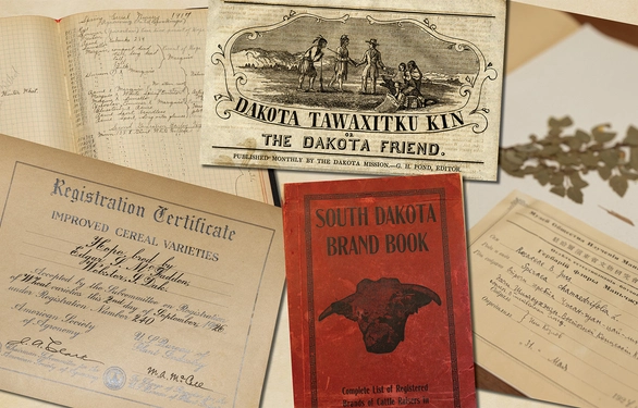 A collection of archived printed materials laid out on a table.