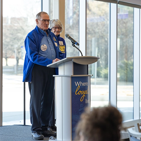Members of the Moeller family speak into a microphone on stage during the Family of the Year presentation.