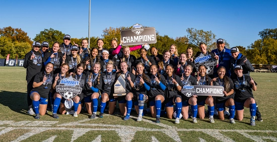 The SDSU Soccer team celebrates after the Summit League Championship game and poses for a team photo.