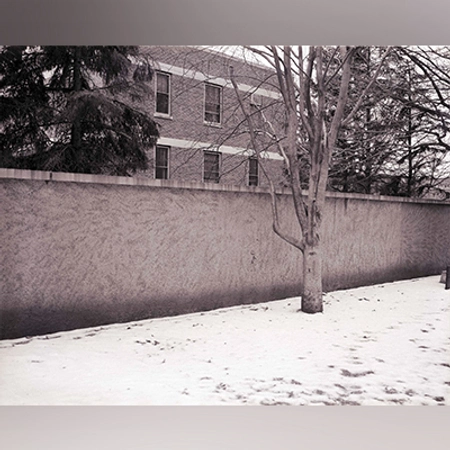 Black and white image of a rammed earth structure.