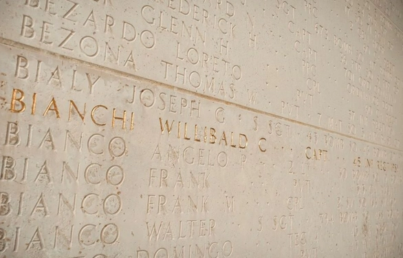 A wall with engraved names, featuring a prominent gold star next to "Bianchi Willibald."