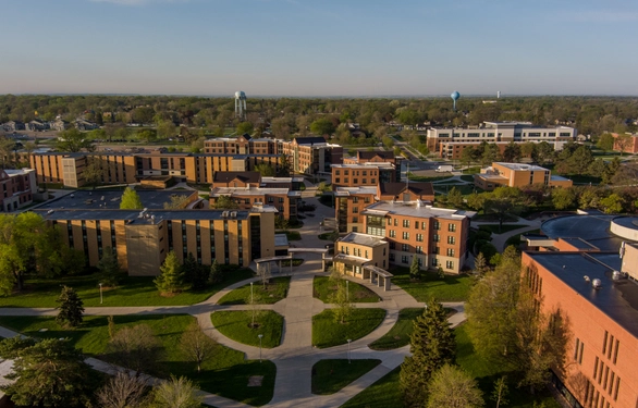 An aerial view of the SDSU college campus featuring multiple brick buildings and intersecting pathways.