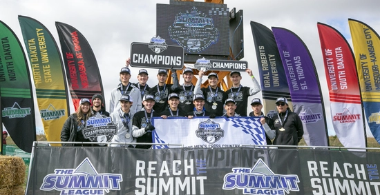 The SDSU Men's Cross Country team is celebrating winning the 2025 Summit League Championship, holding a banner and a trophy.