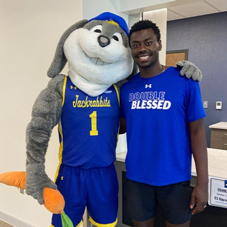 Pierre posing for a photo with SDSU mascot, Jack.