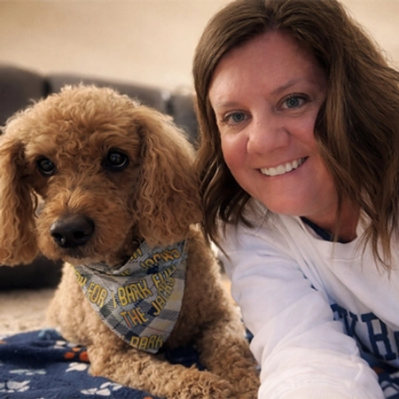 Lindsey Davis smiles with her cute puppy.