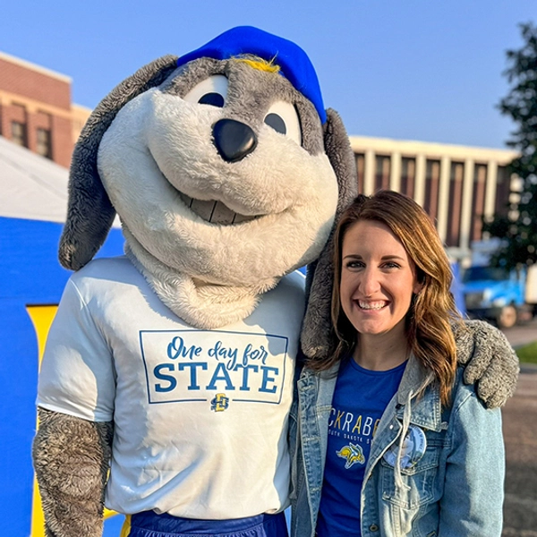 Jenn McCloud and Jack the Jackrabbit smile together during One Day for STATE.