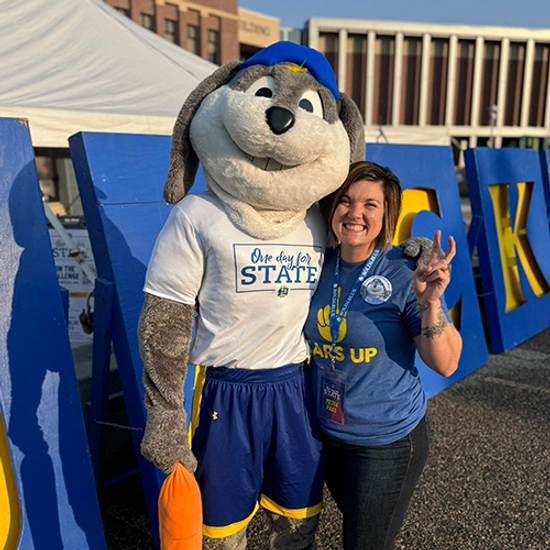 Shelby Hartung smiles happily with Jack the Jackrabbit